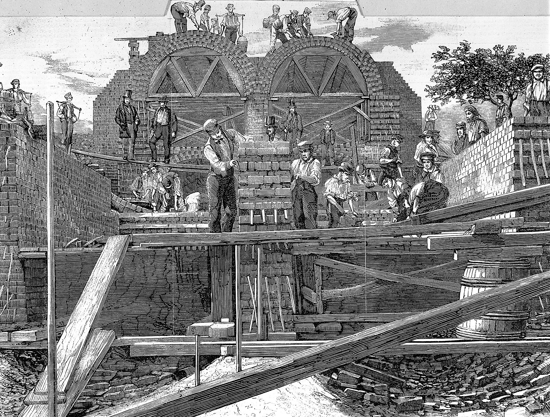 Workers build two large brick sewer arches amid timber supports and scaffolding.
